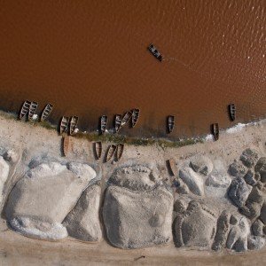 boats parked on the shore of lake Retba or the pink lake