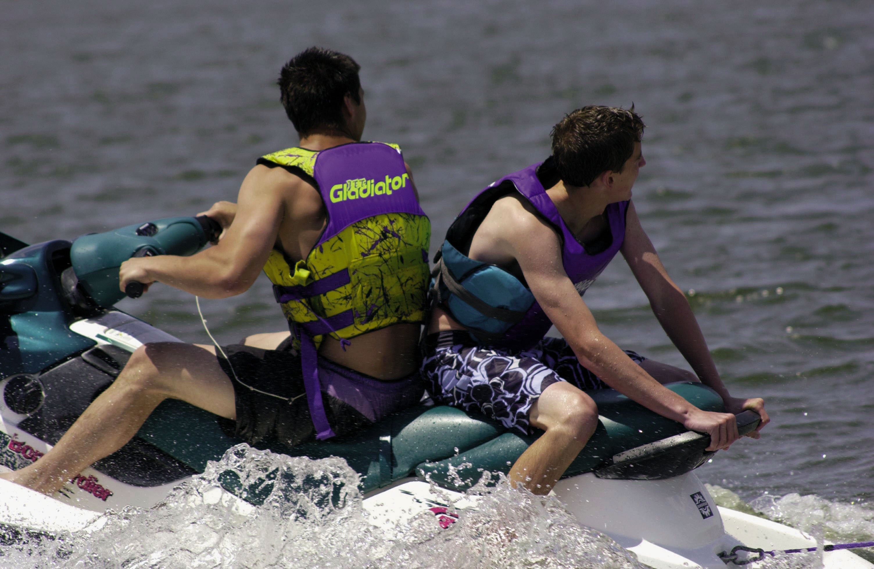 two men with life jackets on a jet ski